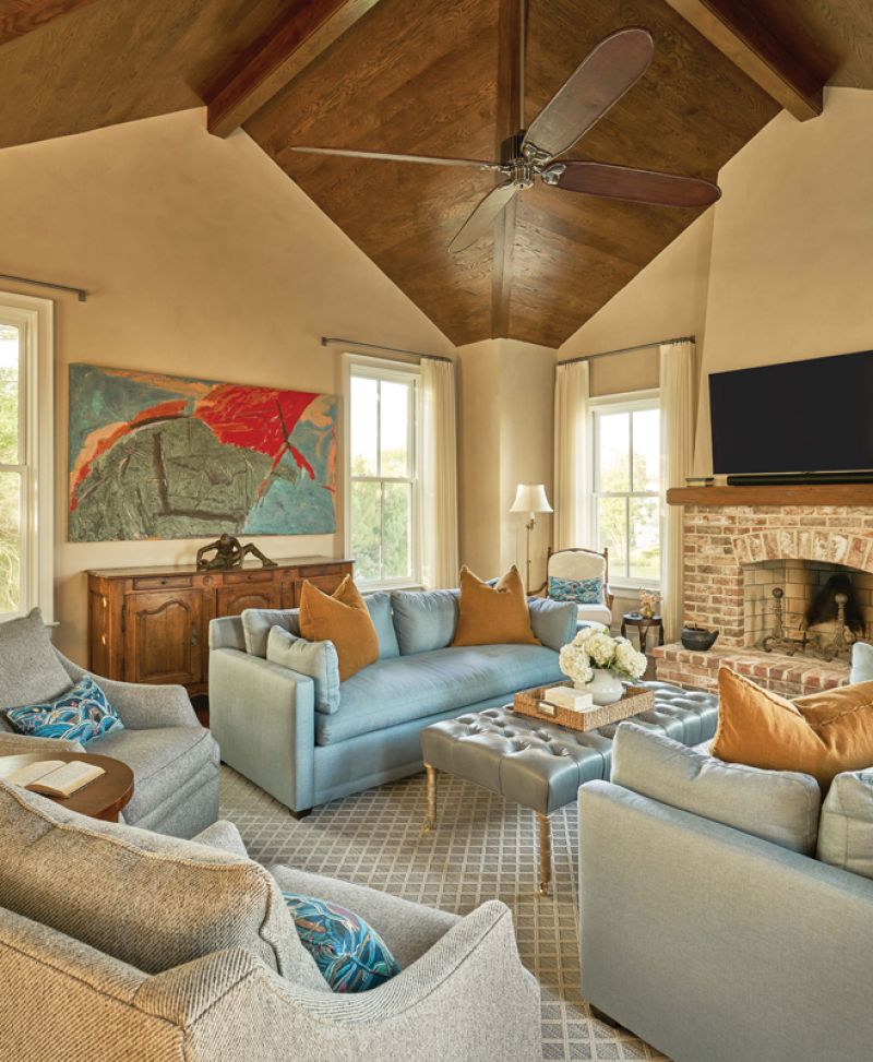 The spacious family room fills one of the two new wings, its soaring ceiling and textured plaster walls adding grandeur to the once humble house.