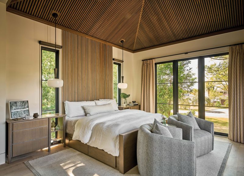 Wood Works: A notable feature of the primary bedroom suite is the headboard designed by architect Aaron Ede. Father-and-son team Steve and Andrew Baldrick of Tightlines Construction built this, and the other wood features of the home.