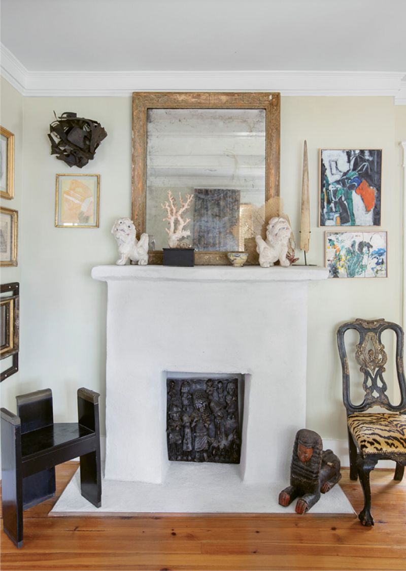 in the mix: In the parlor, Debbie had the fireplace surround stuccoed and painted white for a clean, smooth effect that better showcases the melange of artwork and interesting objects she deems a “necessary excess.”