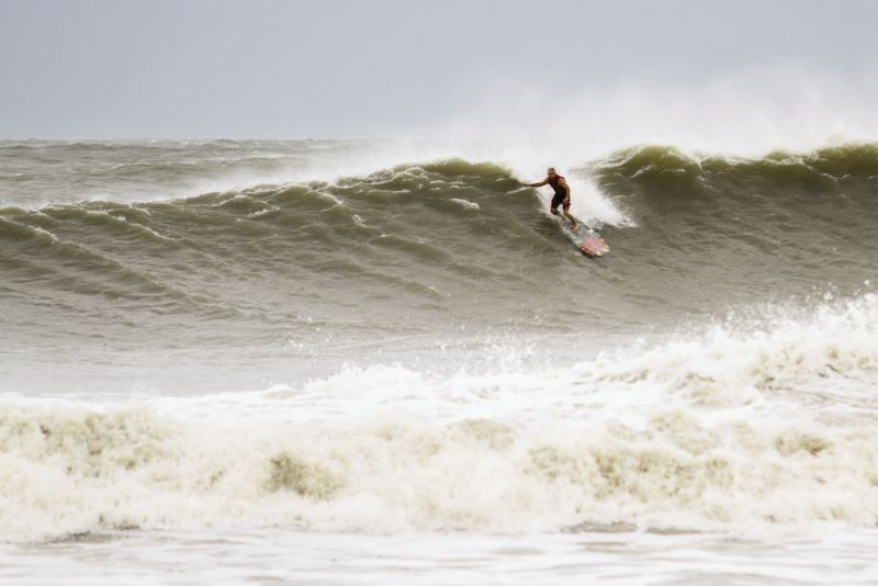 Folly Beach’s hot-rod icon Paul Martin takes the drop on a wild Lowcountry wave, courtesy of Hurricane Irene.