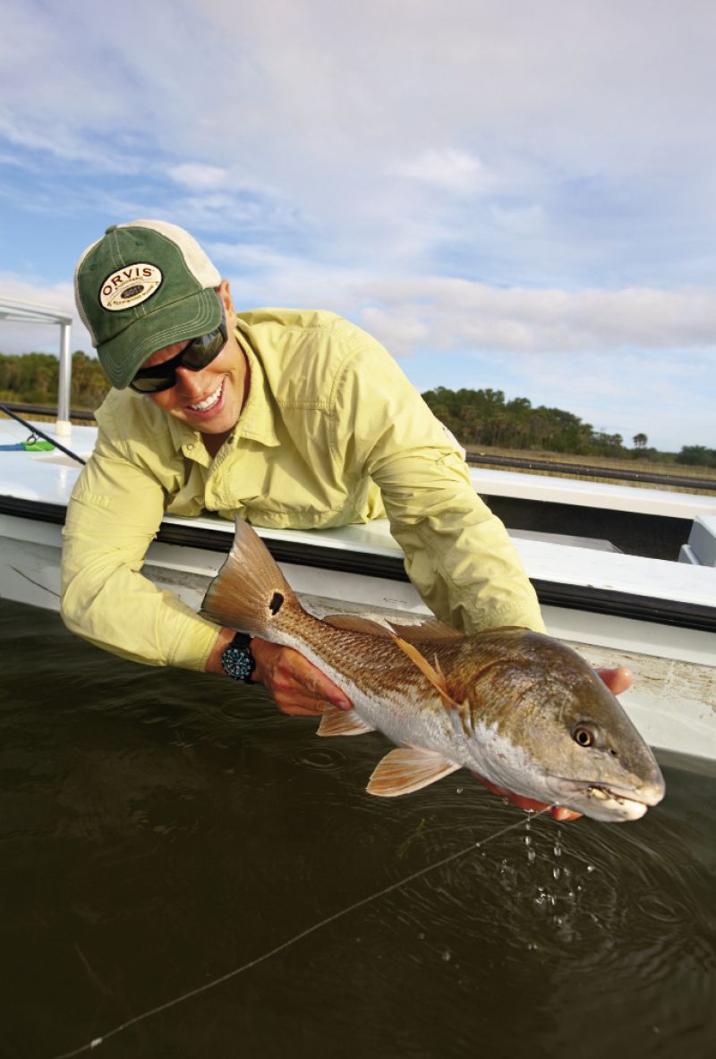Captain Jeremy Mehlhaff admires a good-size redfish caught during an October tailing tide.