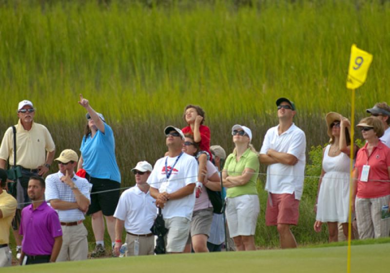 Fans on the 9th green watching an incoming approach shot.