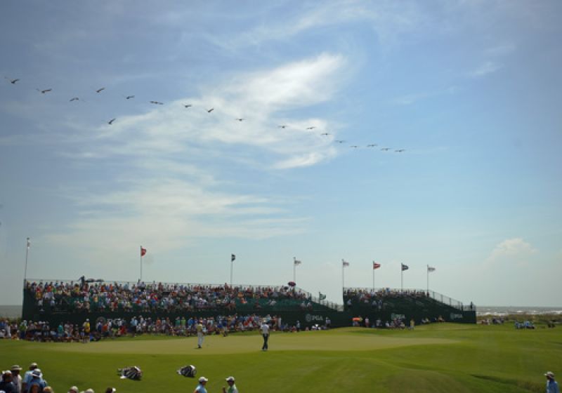A pelican fly-over on the 18th green.