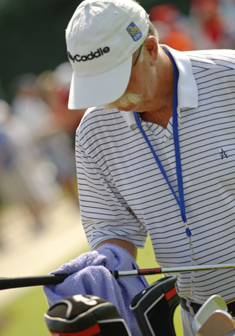 Legendary caddie Fluff preparing Jim Furyk&#039;s clubs for the day.