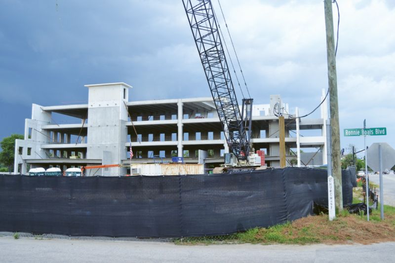 The controversial office building and parking garage being erected at Coleman Boulevard and Mill Street