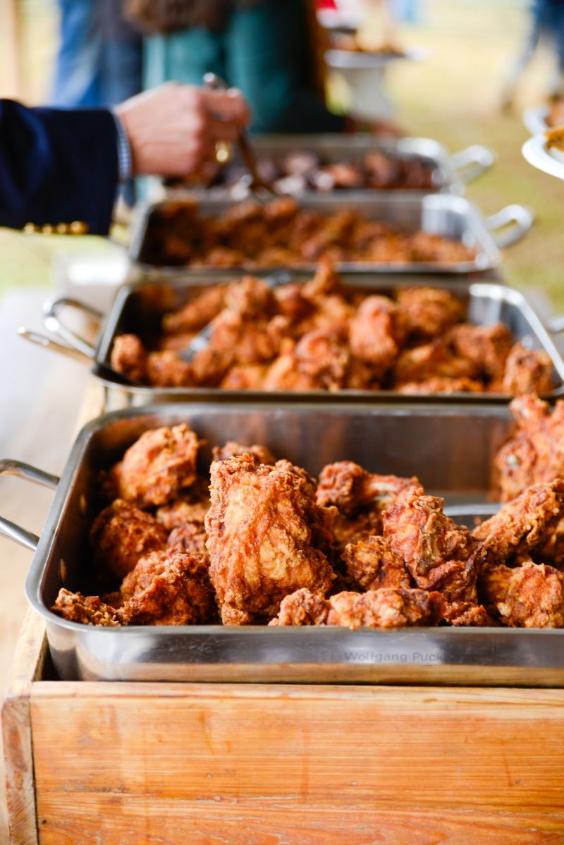 Guests dig into heaps of fried chicken at the VIP tent.