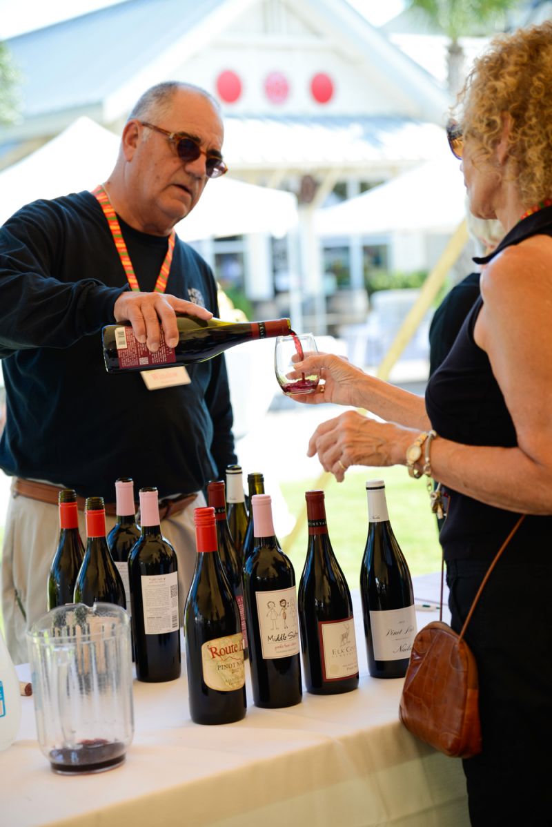 A guest receives a pour of one from one of the innumerable bottles of wine