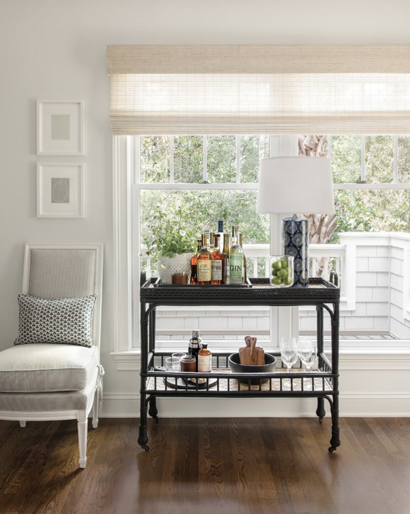 A bar cart from Serena &amp; Lily connects the living room with the adjoining dining area.