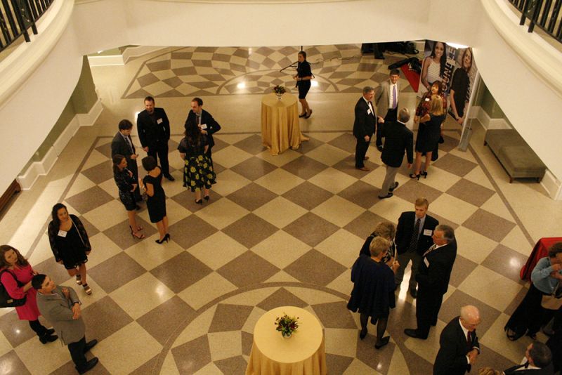 Guests converse in the foyer