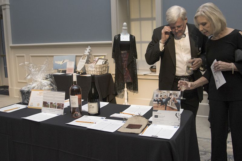 Guests participate in the silent auction during cocktail hour.