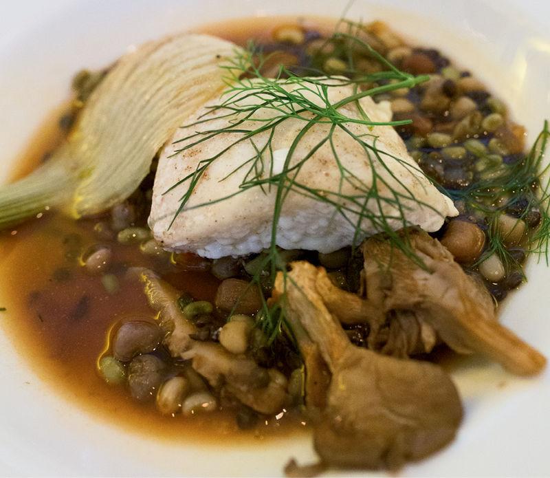 Roasted grouper, local peas and legumes, and caramelized oyster mushrooms with fennel  in a rich umami broth.