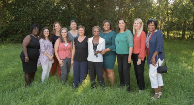 Team Work: Martin-Carrington (center) with her WE BUILD Foundation team—(left to right) Cheryl Wright, Gina Iakovelli, Julie Hussey, Jessica Dye, Gwen Watt, April Magill, Shakeima Chatman, Marie Elana Rowland, Lisa Pansing, and Carmelle Scott—on the site of their first project