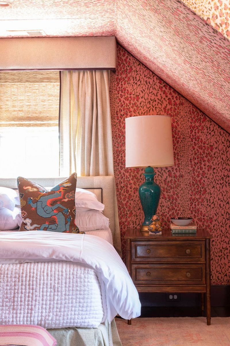 A guest bedroom on the third floor outfitted in pink