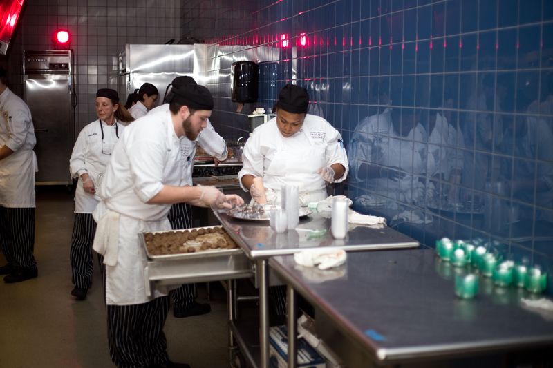 Students prepare hor d&#039;voures in the kitchen.