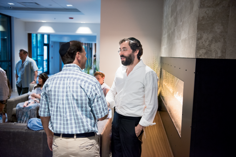 Rabbi Yossi Refson (right) in The Center for Jewish Life’s comfy common area
