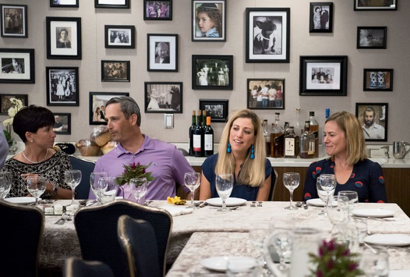 Weekly Shabbat dinners take place in a central kitchen and dining area (complete with gallery walls featuring local families).