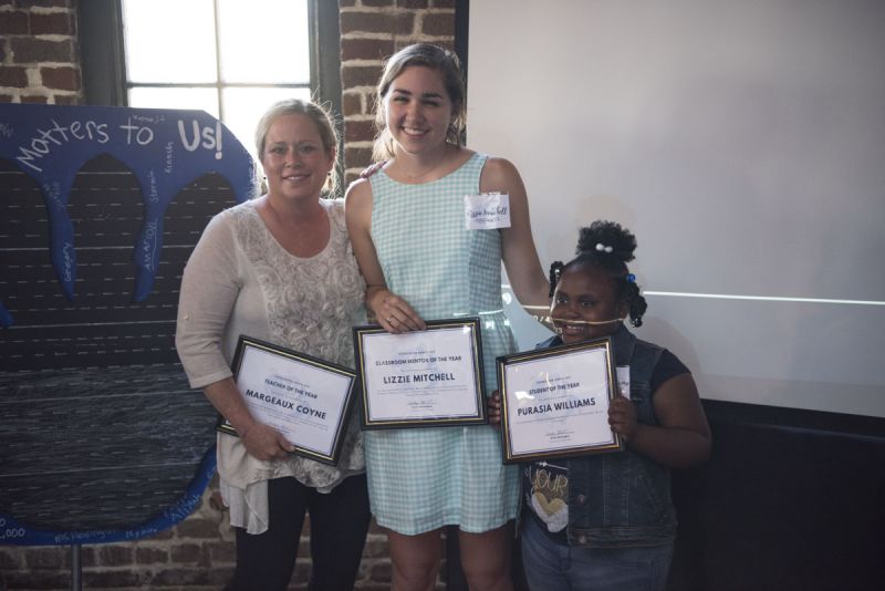 Mrs. C., Lizzie Mitchell, and Purasia Williams proudly display their awards.