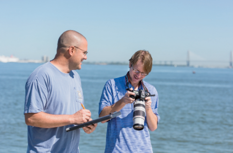 Eric Zolman and Todd Speakman (with camera) work to photo-ID and monitor our dolphin population.
