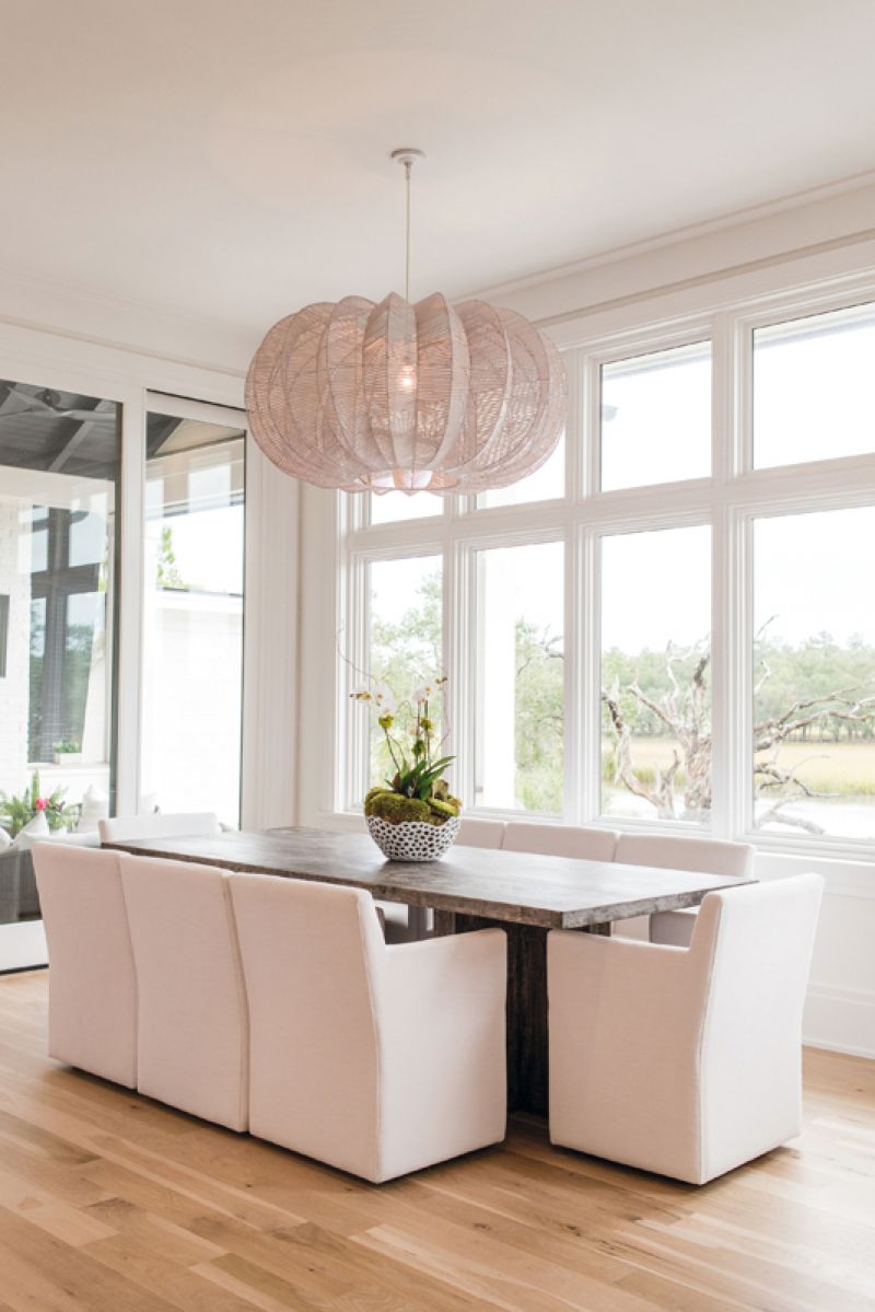 A stone-topped Restoration Hardware dining table overlooks the marsh.