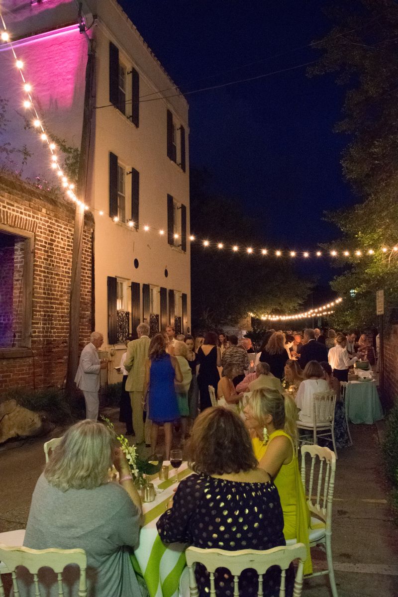 Guests socialize in Bedon’s Alley, all lit up for the occasion.
