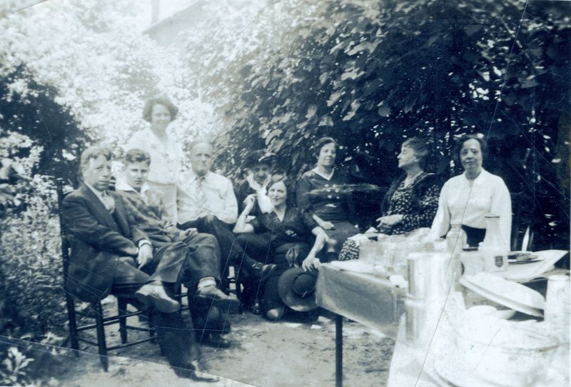 The sisters—Carrie (far right), Mabel (third from right), and Anita with husband Elie Edson (third and fourth from left) at a Charleston garden party in the 1930s.