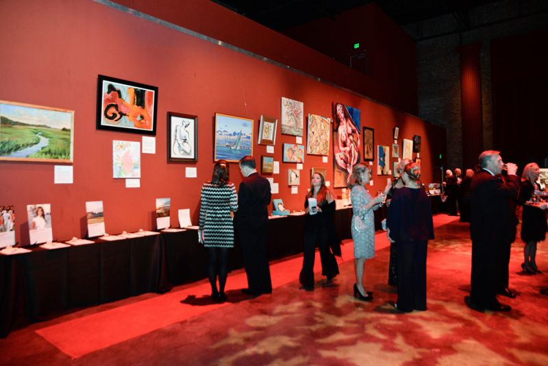 Attendees admired the wall of artwork on display.