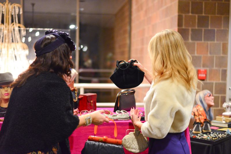 Guests take a closer look at the purses.