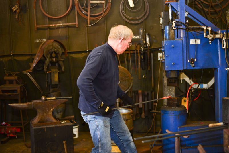 An Avrett employee used a 275-pound hammer to bend metal.