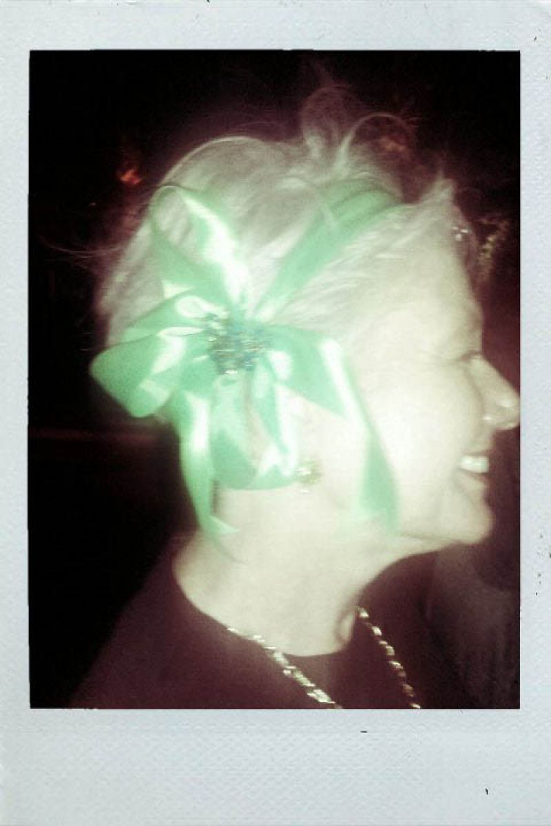 Lynn adds a great ribboned headpiece to her look.