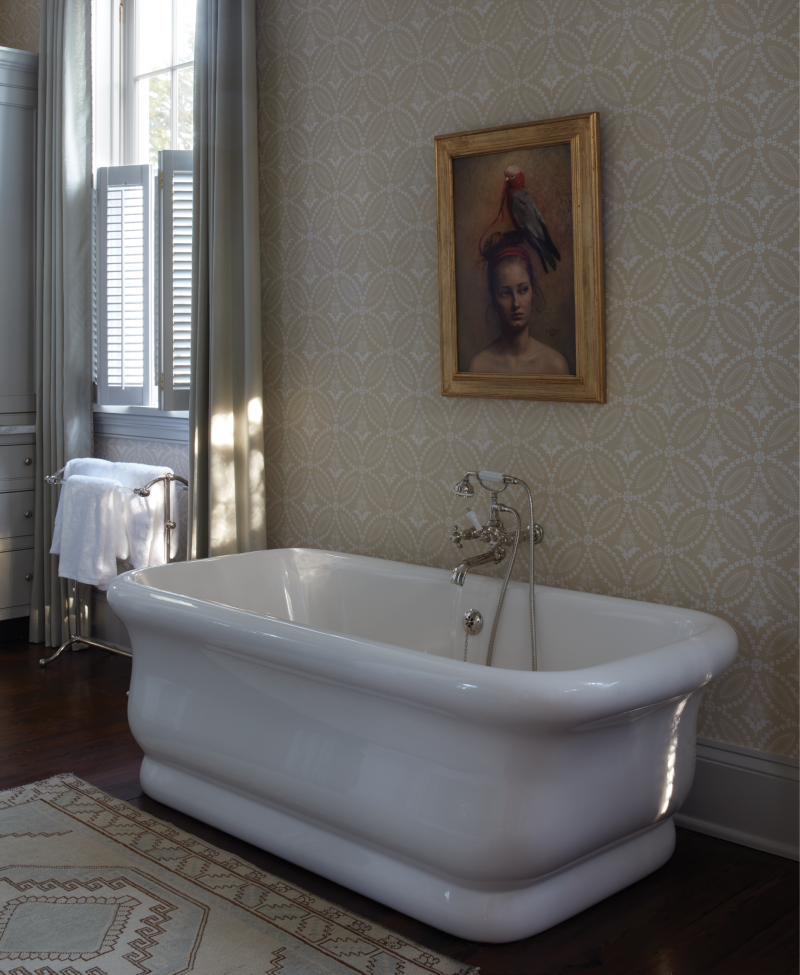 Bathing Beauty: A figurative oil painting by Danish artist Louise C. Fenne presides over the Waterworks “Empire” soaking tub in the primary bathroom.