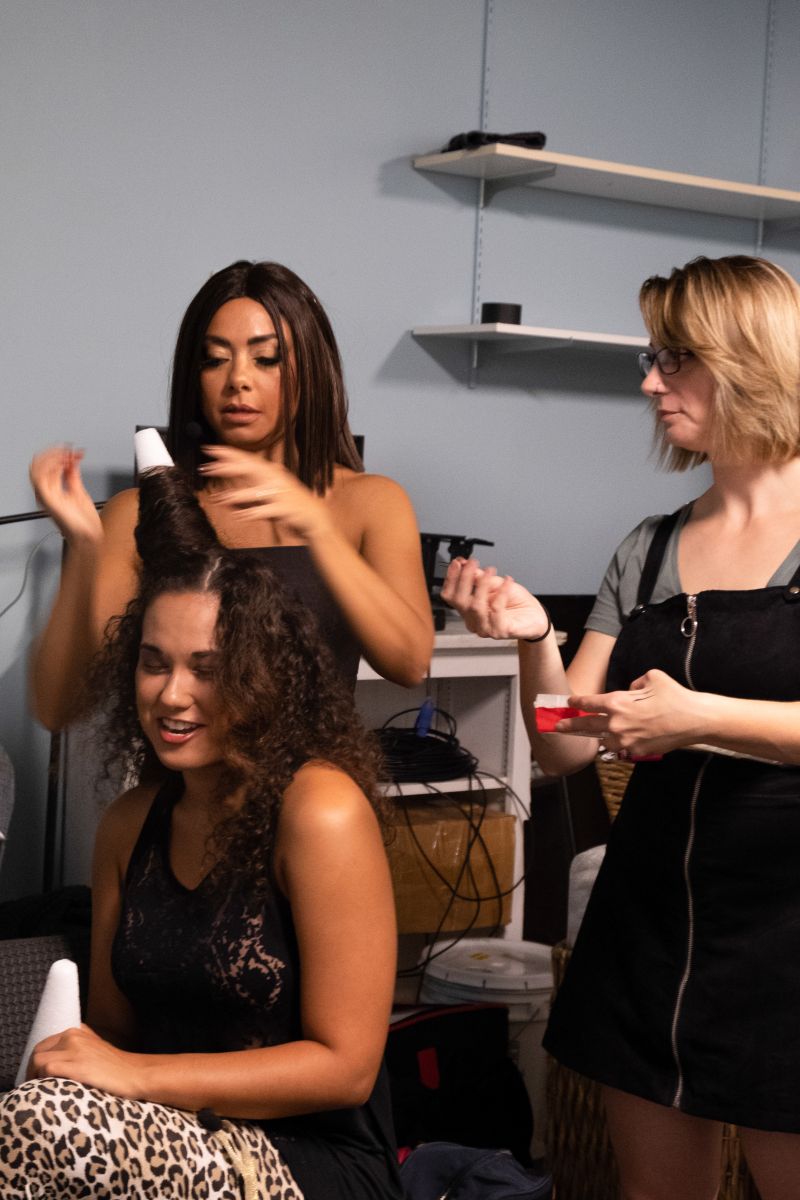 Andrea Serrano helps a fellow Spice Girl prep for the show.