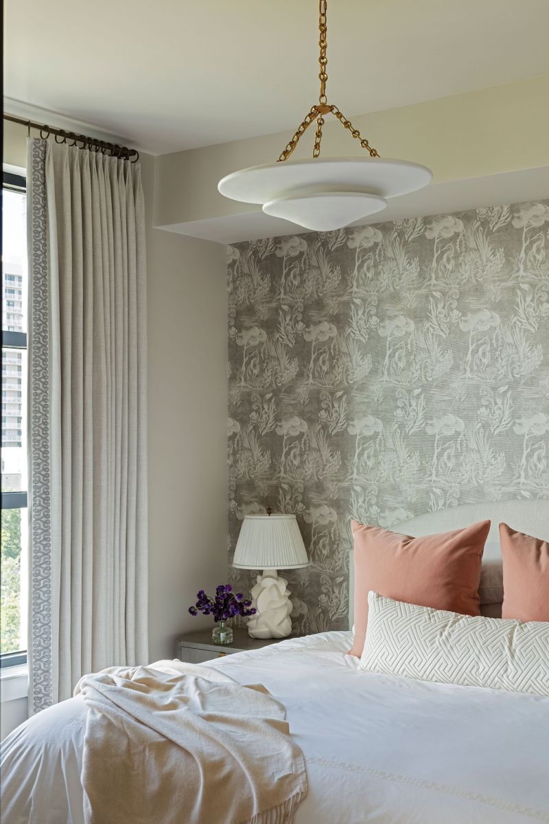 Creature Comforts: Balla’s bedroom suite has a sift, feminine feel, with floral wallpaper by Victoria Larson and peach pillows from Little Design Co. A pair of handcrafted table lamps by Victoria Ellis and a white Visual Comfort light fixture complement the light, bright decor.