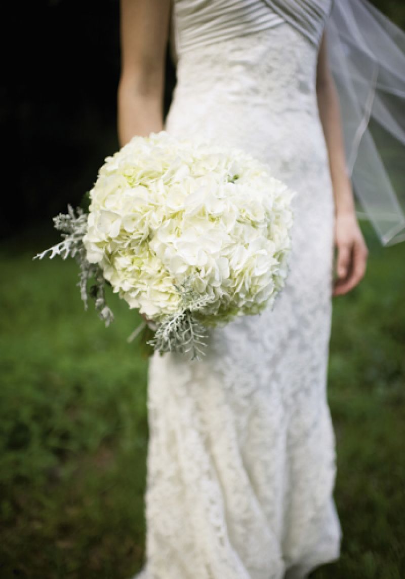 TONE ON TONE: A Charleston Bride took a cue from the bride’s Modern Trousseau lace gown to create a textured bouquet of ivory hydrangeas tinged with silver-green Dusty Miller.