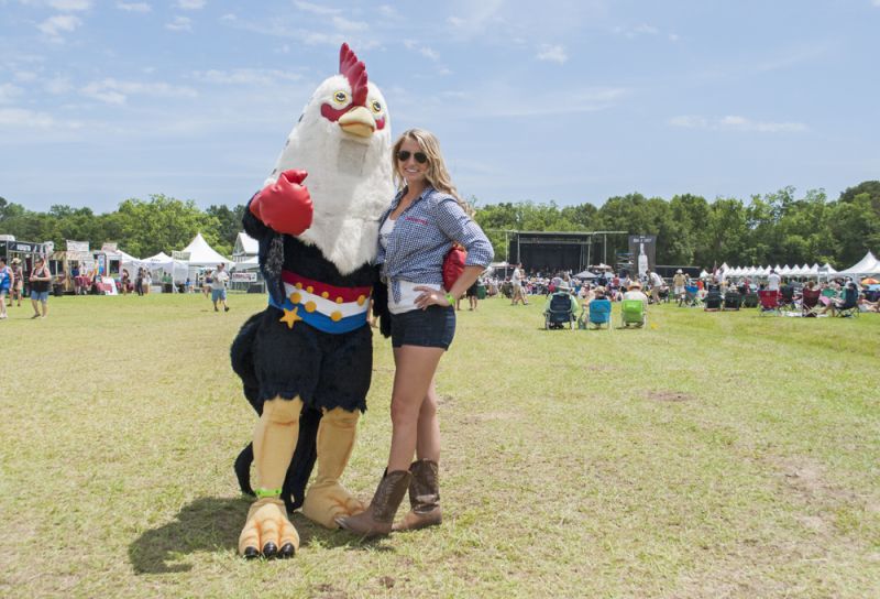 Cowgirl Caroline Gilbert posed with a life-sized rooster.