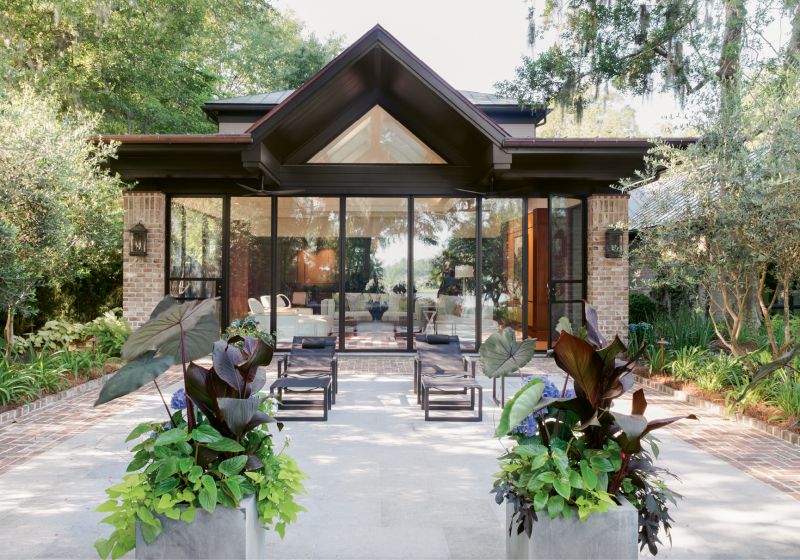 Improved Outlook: With wall-to-wall windows revealing an Intracoastal panorama, the new addition transforms what was a screened porch and dark den into an outdoors-oriented living space.