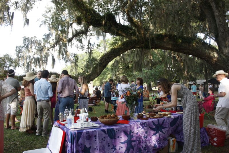 Guests gathered underneath the live oaks to enjoy their prepared picnic spreads.