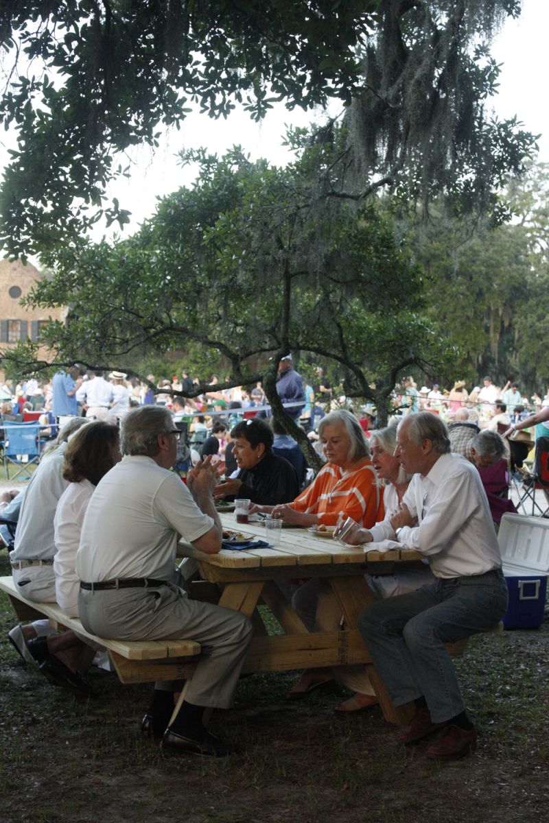 Guests snacked on gourmet fare at community-style picnic tables.