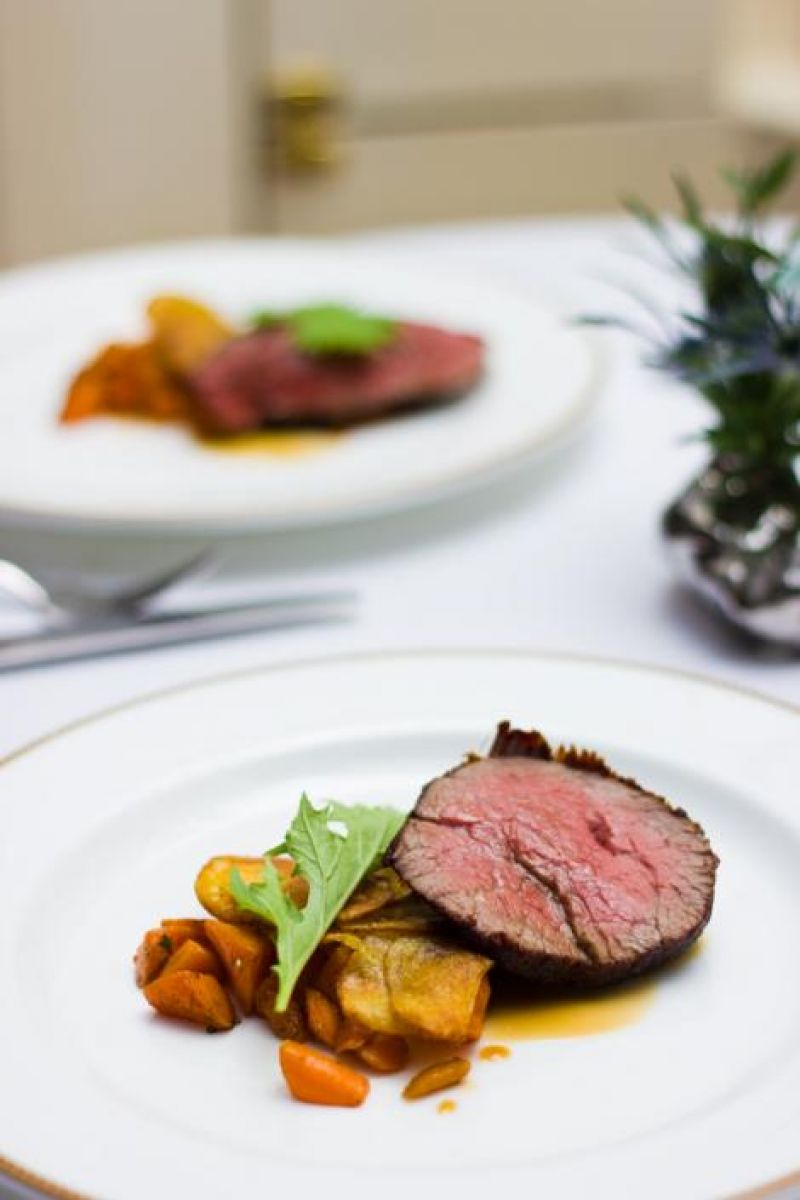 McCrady&#039;s wagyu beef tenderloin served with potato galette, carrot, and sauce perigord.