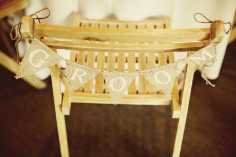 SAVE MY SEAT: His and her burlap banners from Etsy&#039;s Funkyshique hung on the couple&#039;s chairs.