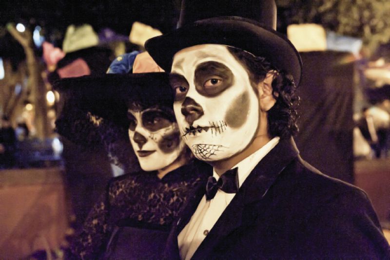 the Day of the Dead brings out revelers in dramatic attire to honor their ancestors.