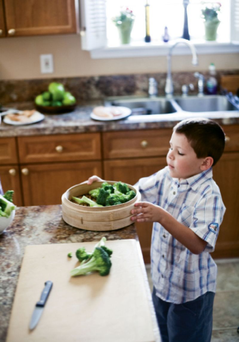 Veggie Tales: Christian pitches in by arranging the chopped broccoli in a bamboo steamer tray.