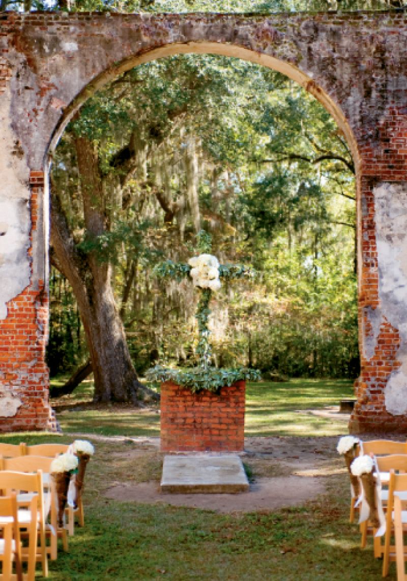 Ashley Rhodes Events covered a cross and the altar in greens and hydrangea for an organic look that melded with the setting.