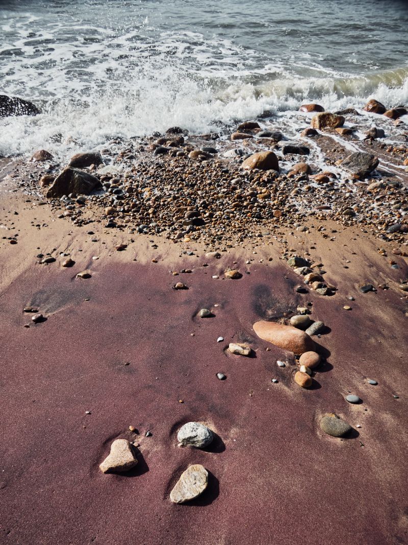 In Montauk, a beach of rocks tumbled by waves and interesting sand colors, ranging  from beige and amber to deep plum.