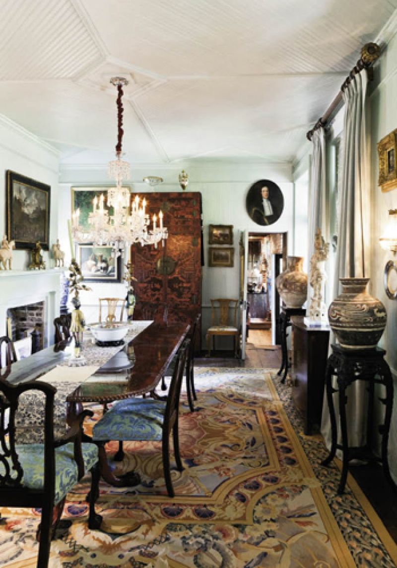 Distinguished by bead-board ceilings and walls, the dining room is centered by an elegant, circa-1860 chandelier that extends its radiance across an 18th-century American mahogany table. On display are Chinese earthenware horses from the Tang Dynasty (left), as well as ancient Persian and Chinese rice urns that were not originally intended as artwork but rather created to be utilitarian, an historical and cultural factor that the collectors find, in itself, to be beautiful.