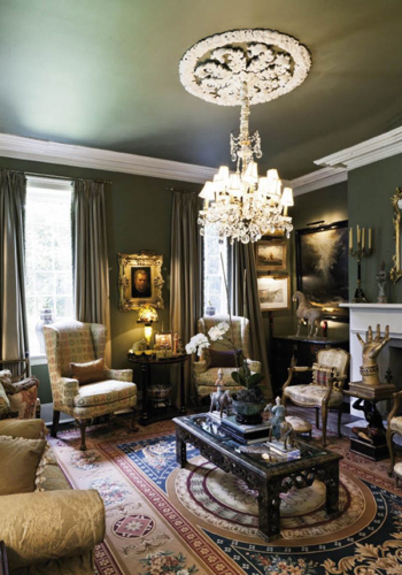 n the formal living room, an elegant French chandelier shines a light on an early-20th-century wood and gilt hand, as if beckoning visitors to the hearth.