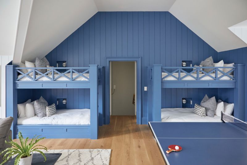 Personal Quarters: Above the garage, a large guest suite with bunk beds and a separate guest room provides a destination for sleepovers, as well as hosting friends and family. The bunks and paneled walls, painted in Sherwin Williams “Inky Blue,” add a playful feel.