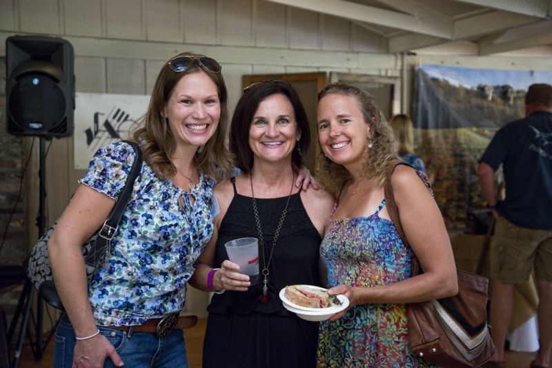 LLF board member Elena Hacker, executive director Jamee Haley, and Glass Onion’s co-owner-and-chef Sarah O’Kelly enjoy local beer and food before the live auction begins.