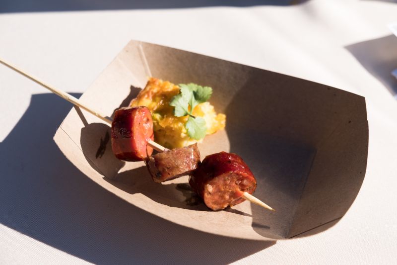 The sausage sampler from Lewis Barbecue&#039;s featured their Hot Guts, Lamb Cumin, and Green Chile + Cheese sausages, with a side of Green Chile Corn Puddin&#039;