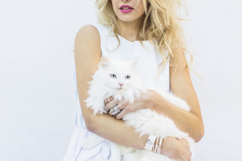 Comme des Garçons vest, $395 at Worthwhile; Christina Jervey sterling silver cuffs, $325 and $395 at christinajervey.com; “Oser” silver ring by Atchoo, $135 at Out of Hand; Snowflake the cat courtesy of Pet Helpers, call (843) 795-1110 to adopt your own feline friend.