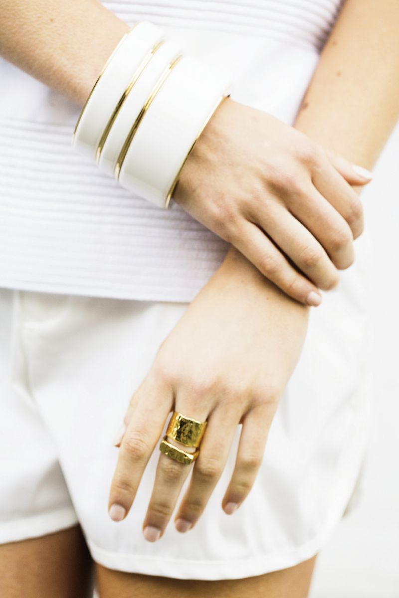 White bangles with gold rim by Ben-Amun for Isaac Manevitz, $80-$130, at Berlin’s for Women; 14K gold-plated rings, both by Christina Jervey, $115 &amp; $125, at christinajervey.com; “Ringer” tee, $290, &amp; “Ladson” twill shorts, $190, both by Troubadour at troubadourclothing.com